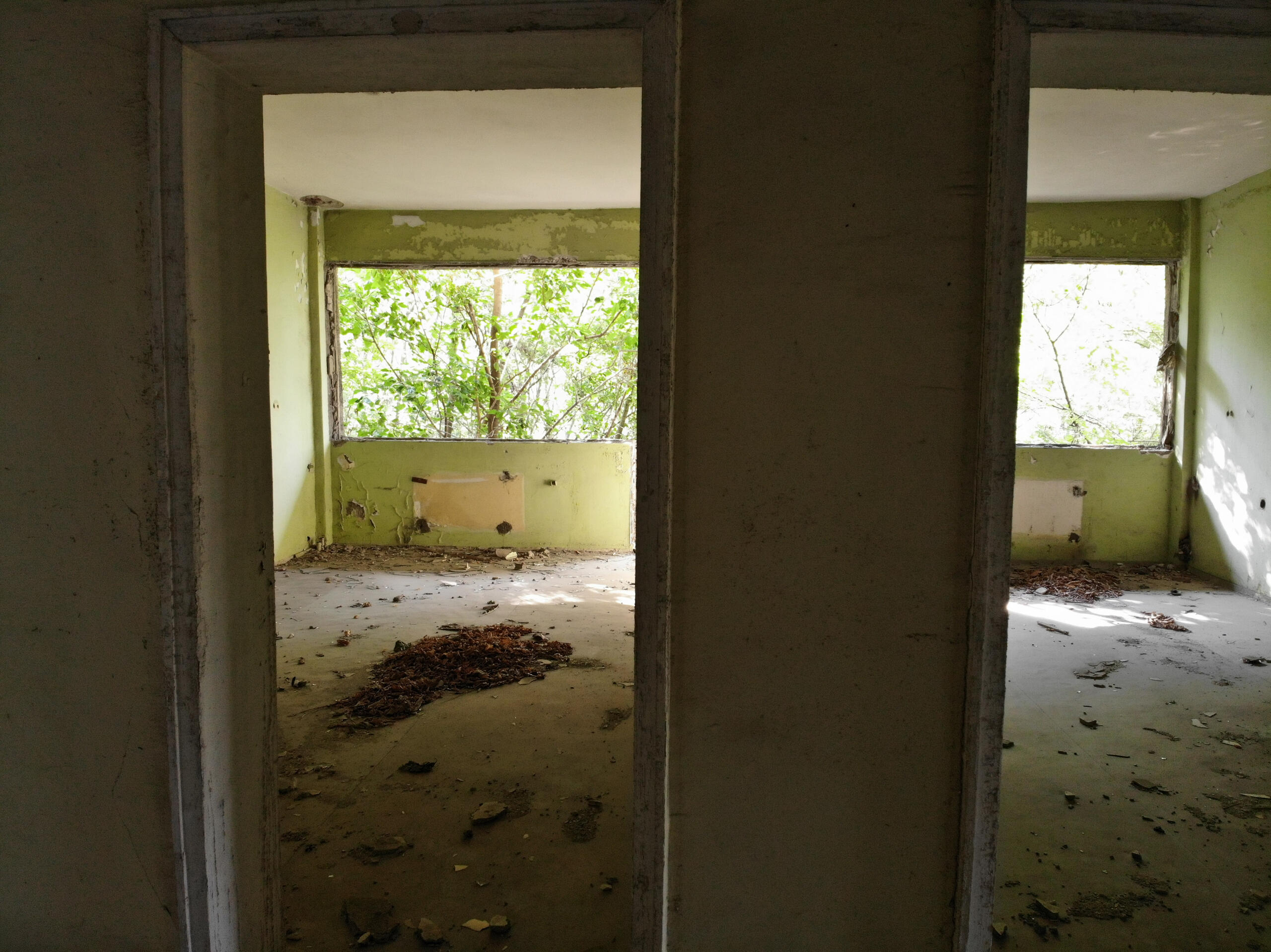 Through-view of multiple interior spaces showing concrete structural elements