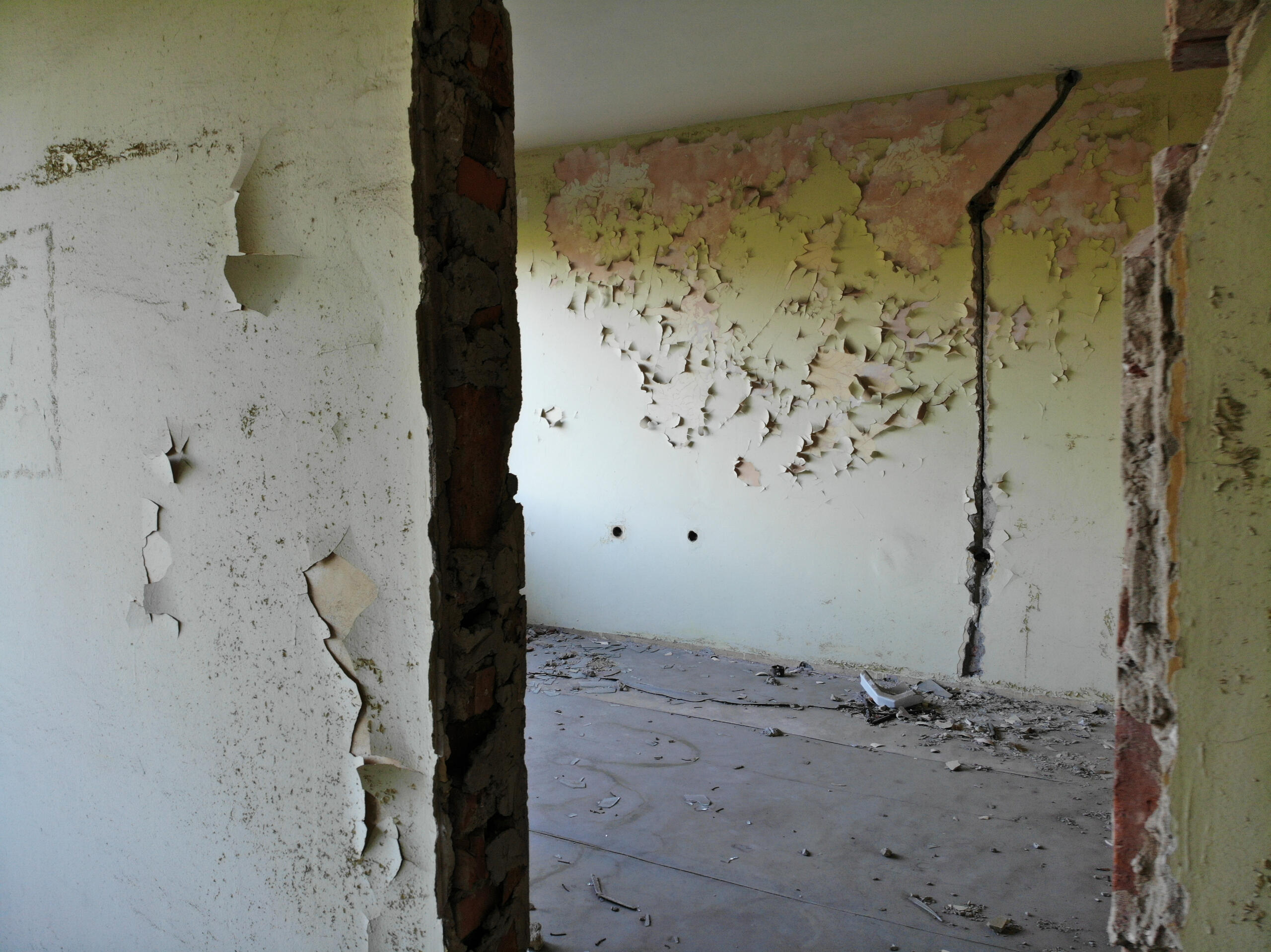 Interior space showing existing surface finishes requiring full demolition and refinishing